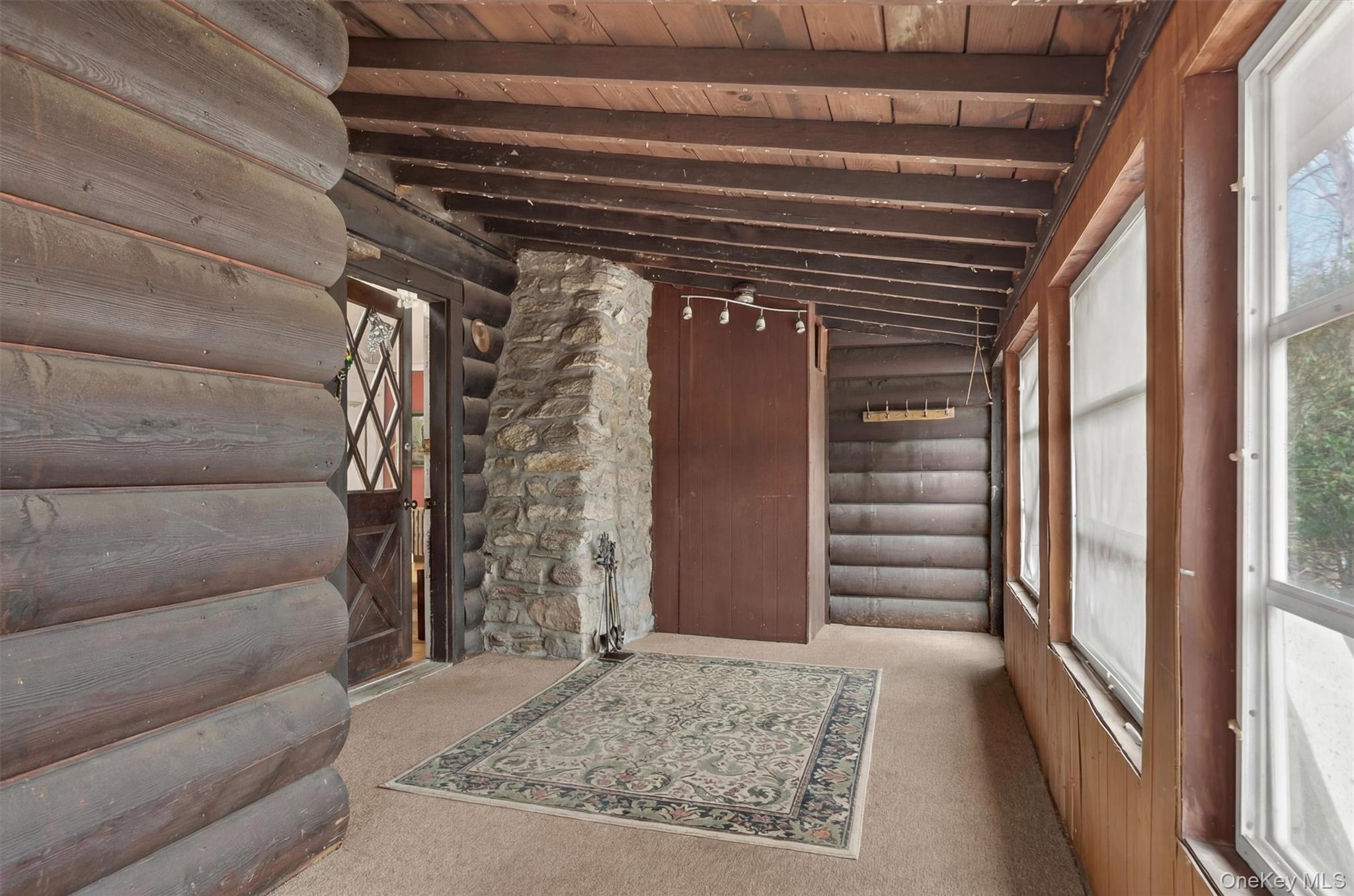 13 Perry Trail Carmel, NY 10512 - Photo 6 of 49 Showcasing the home’s unique quarter-log siding and striking stone chimney