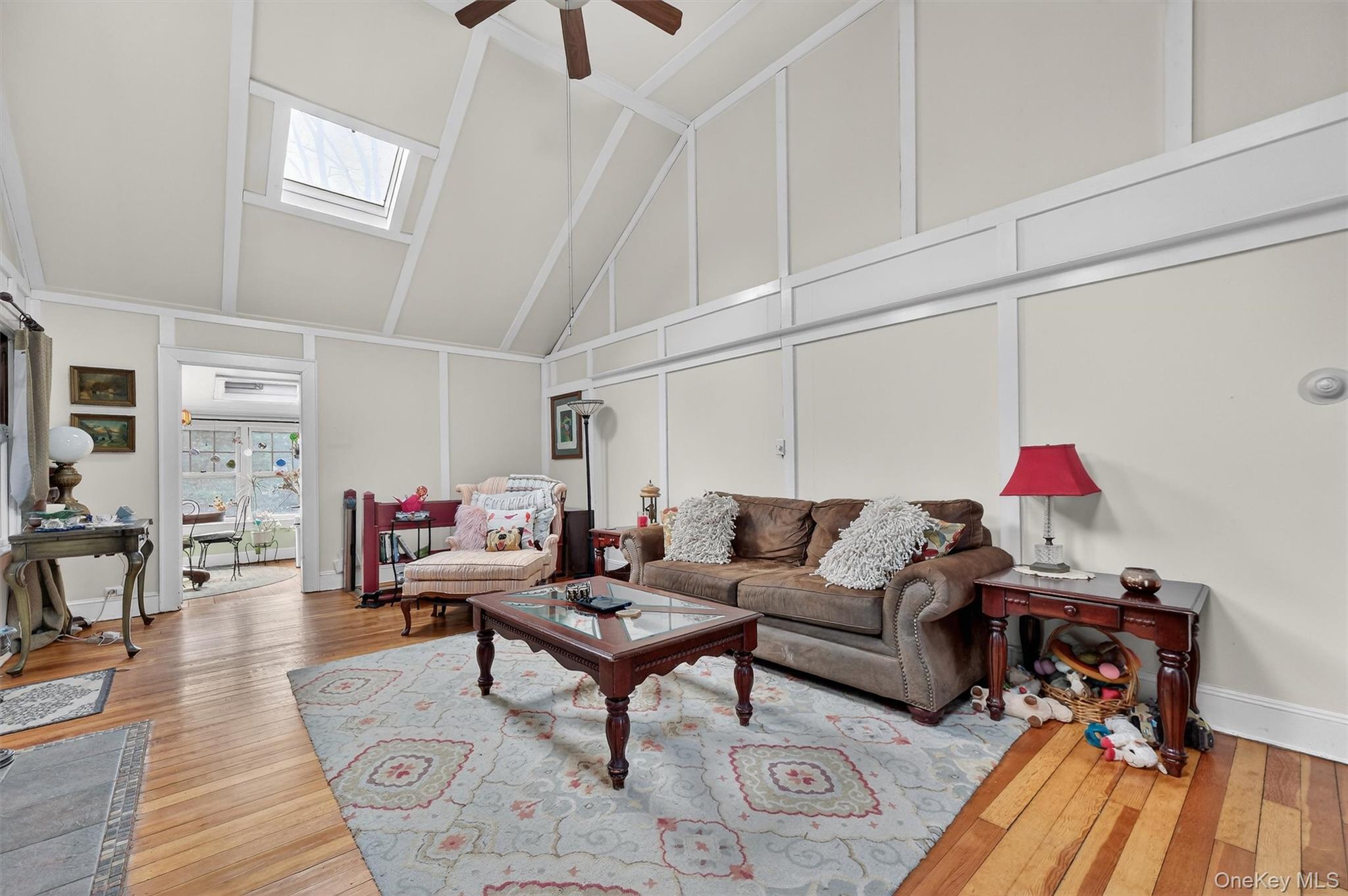 13 Perry Trail Carmel, NY 10512 - Photo 7 of 49 An inviting living space designed for comfort and connection. Skylights and windows fill the space with natural light. Hardwood floors add warmth and character throughout