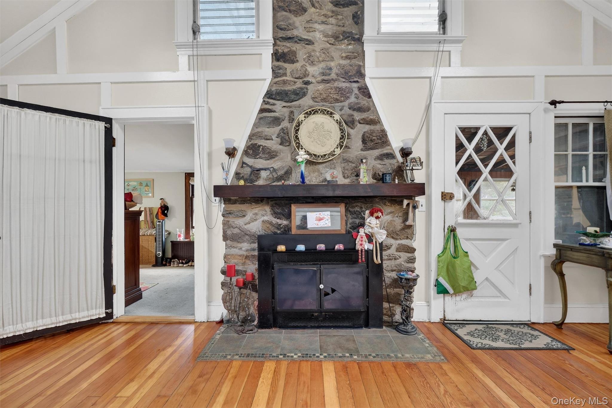 13 Perry Trail Carmel, NY 10512 - Photo 9 of 49 Striking stone fireplace with chimney rising to the high ceilings - a true focal point. Step right out to the covered porch - perfect for relaxing or entertaining