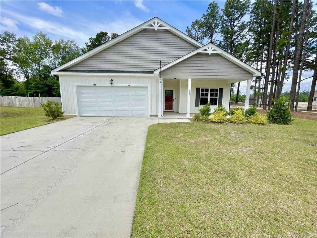 5177 Maxwell Road Stedman, NC 28391 - Photo 1 of 24 a front view of a house with a yard and garage