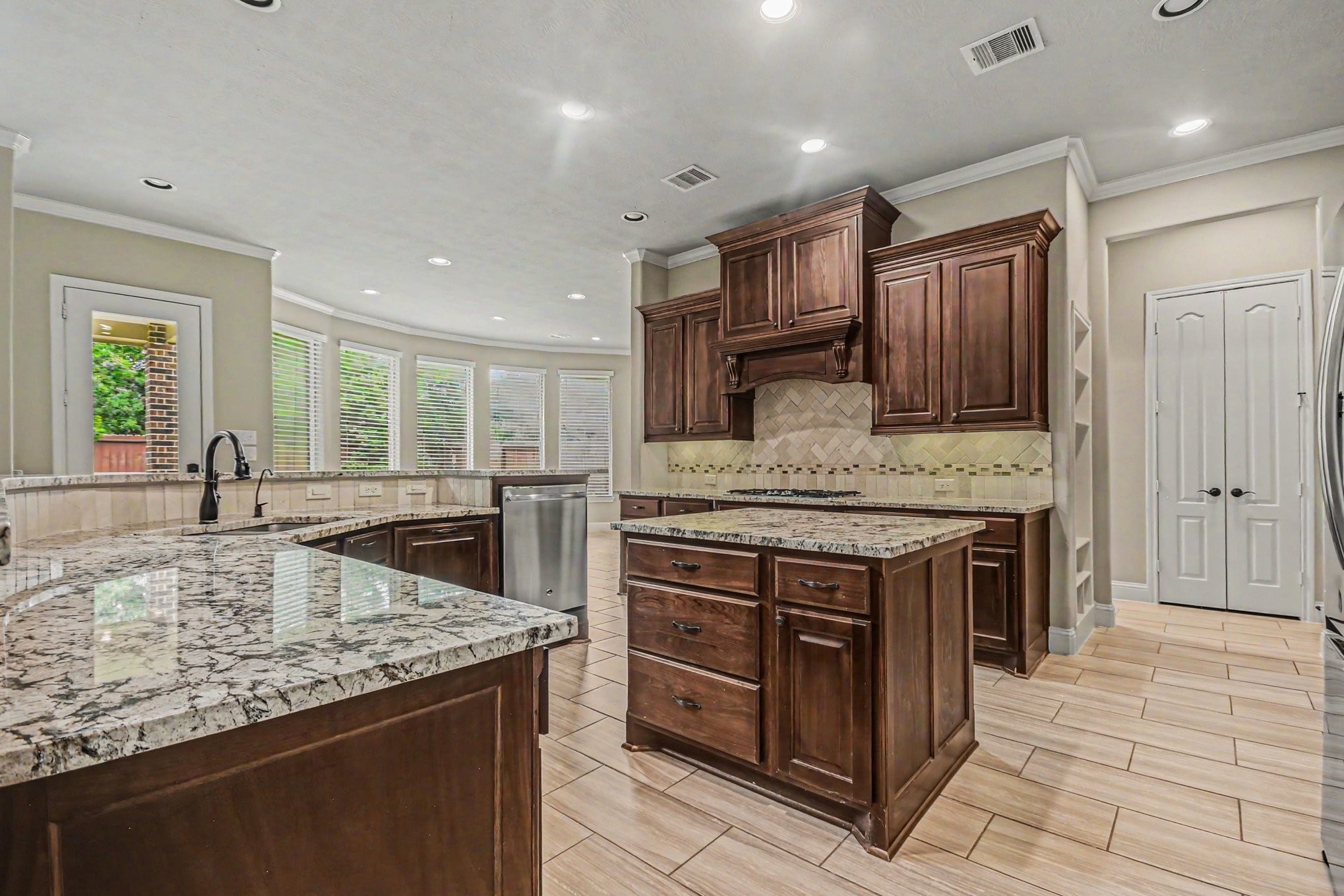 3310 Ralston Edge Lane Houston, TX 77059 - Photo 16 of 50 a kitchen with stainless steel appliances granite countertop a stove a sink and a microwave