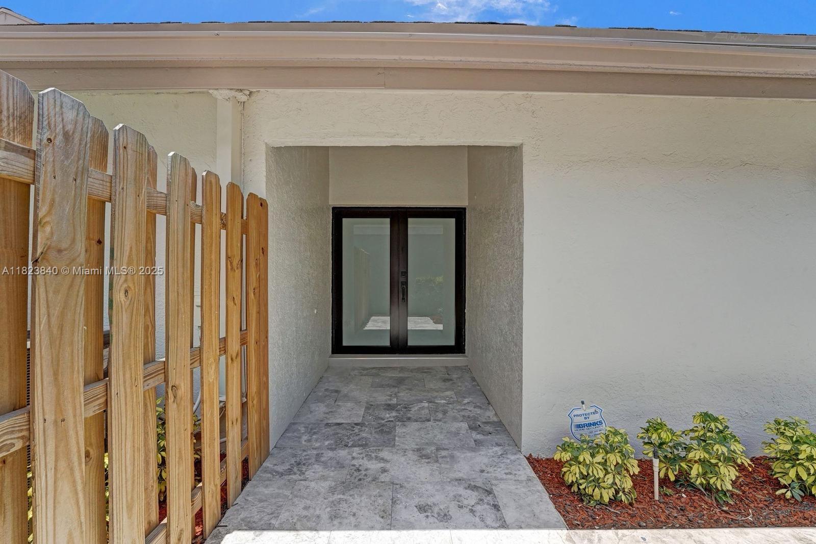 7340 Andorra Place Boca Raton, FL 33433 - Photo 25 of 99 a view of a hallway with wooden floor and a potted plant