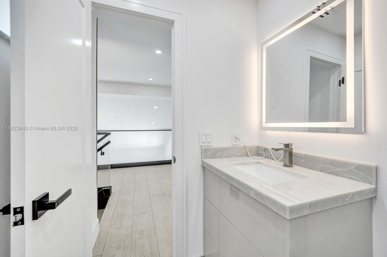 7340 Andorra Place Boca Raton, FL 33433 - Photo 27 of 99 a bathroom with a sink and a mirror