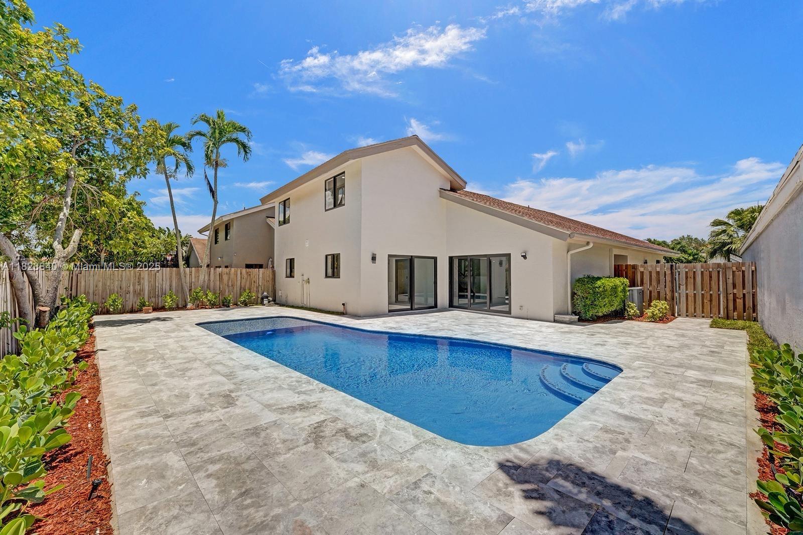 7340 Andorra Place Boca Raton, FL 33433 - Photo 43 of 99 a view of a house with backyard and wooden fence
