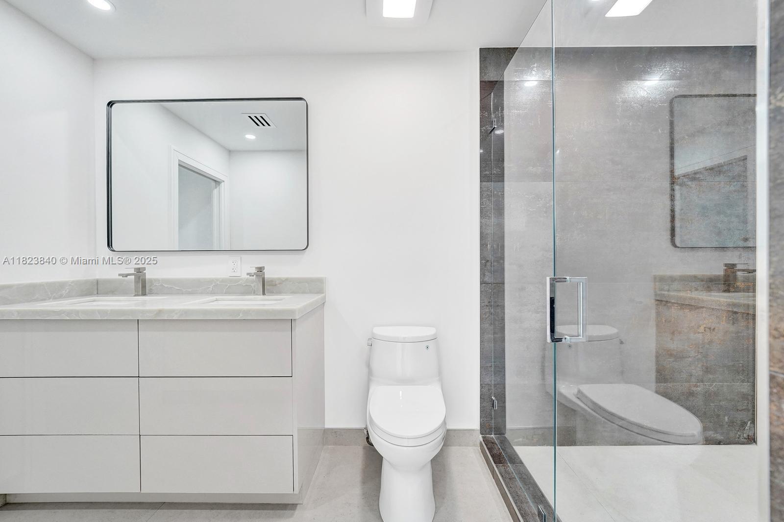 7340 Andorra Place Boca Raton, FL 33433 - Photo 60 of 99 a bathroom with a sink a toilet and shower