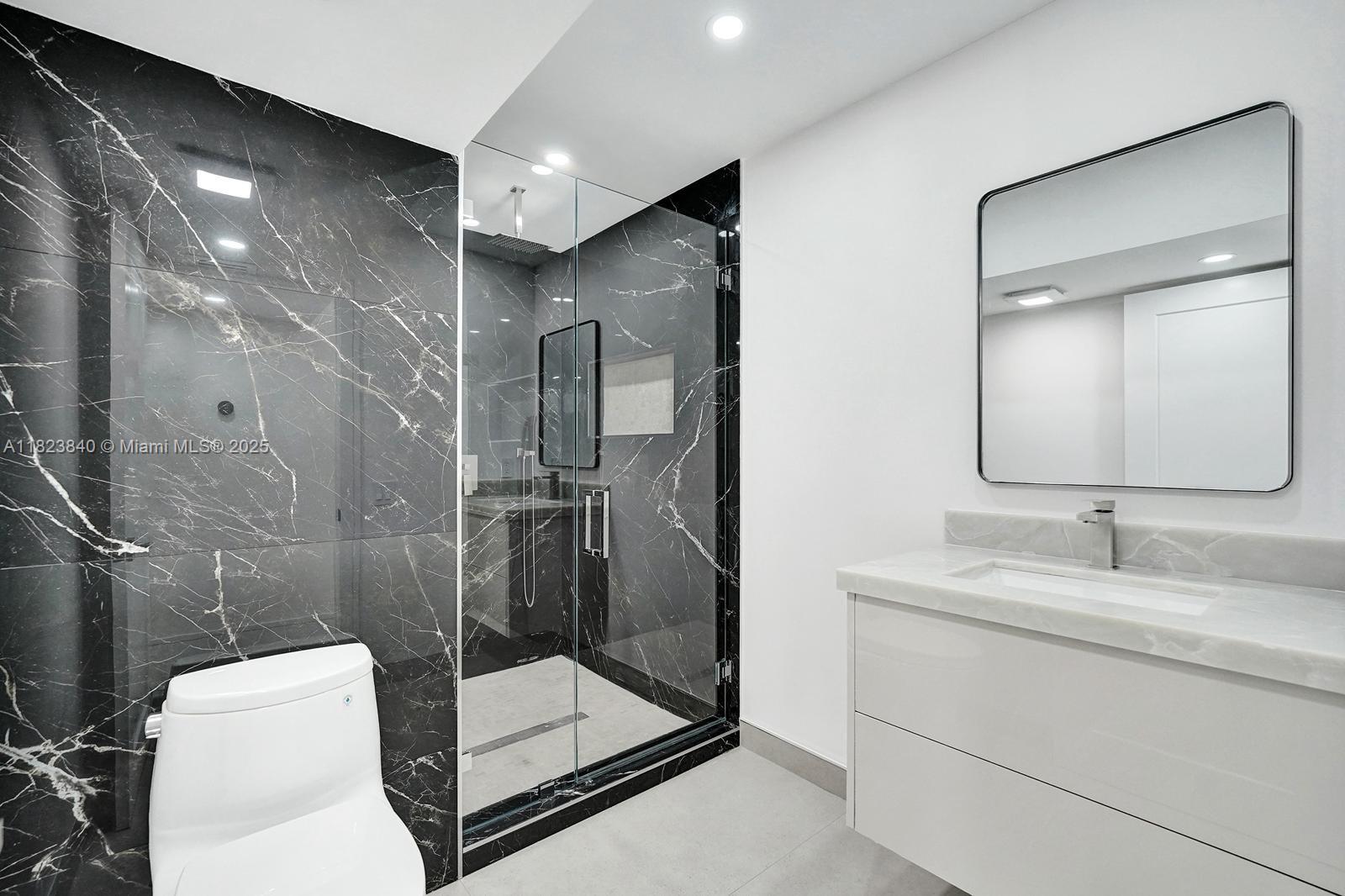 7340 Andorra Place Boca Raton, FL 33433 - Photo 72 of 99 a bathroom with a toilet sink and shower