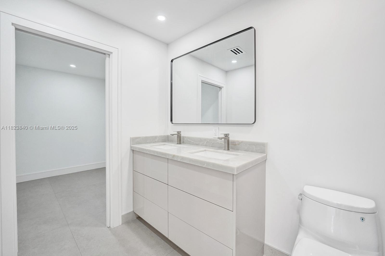 7340 Andorra Place Boca Raton, FL 33433 - Photo 73 of 99 a bathroom with a sink a toilet and a mirror