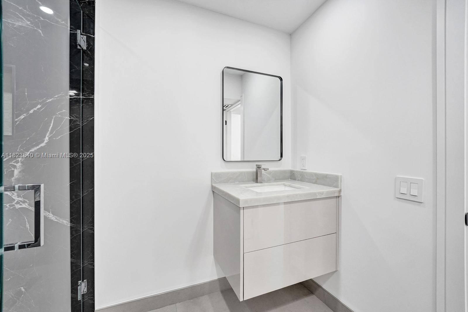 7340 Andorra Place Boca Raton, FL 33433 - Photo 74 of 99 a bathroom with a granite countertop sink and a mirror