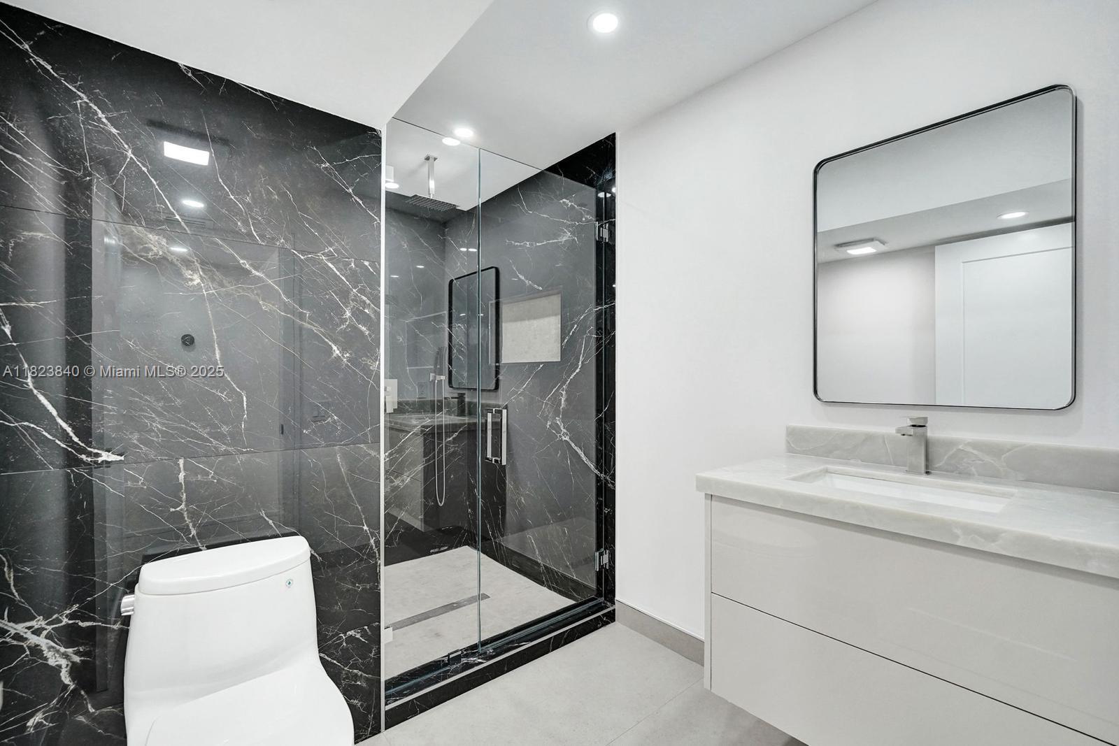 7340 Andorra Place Boca Raton, FL 33433 - Photo 91 of 99 a bathroom with a toilet sink and shower