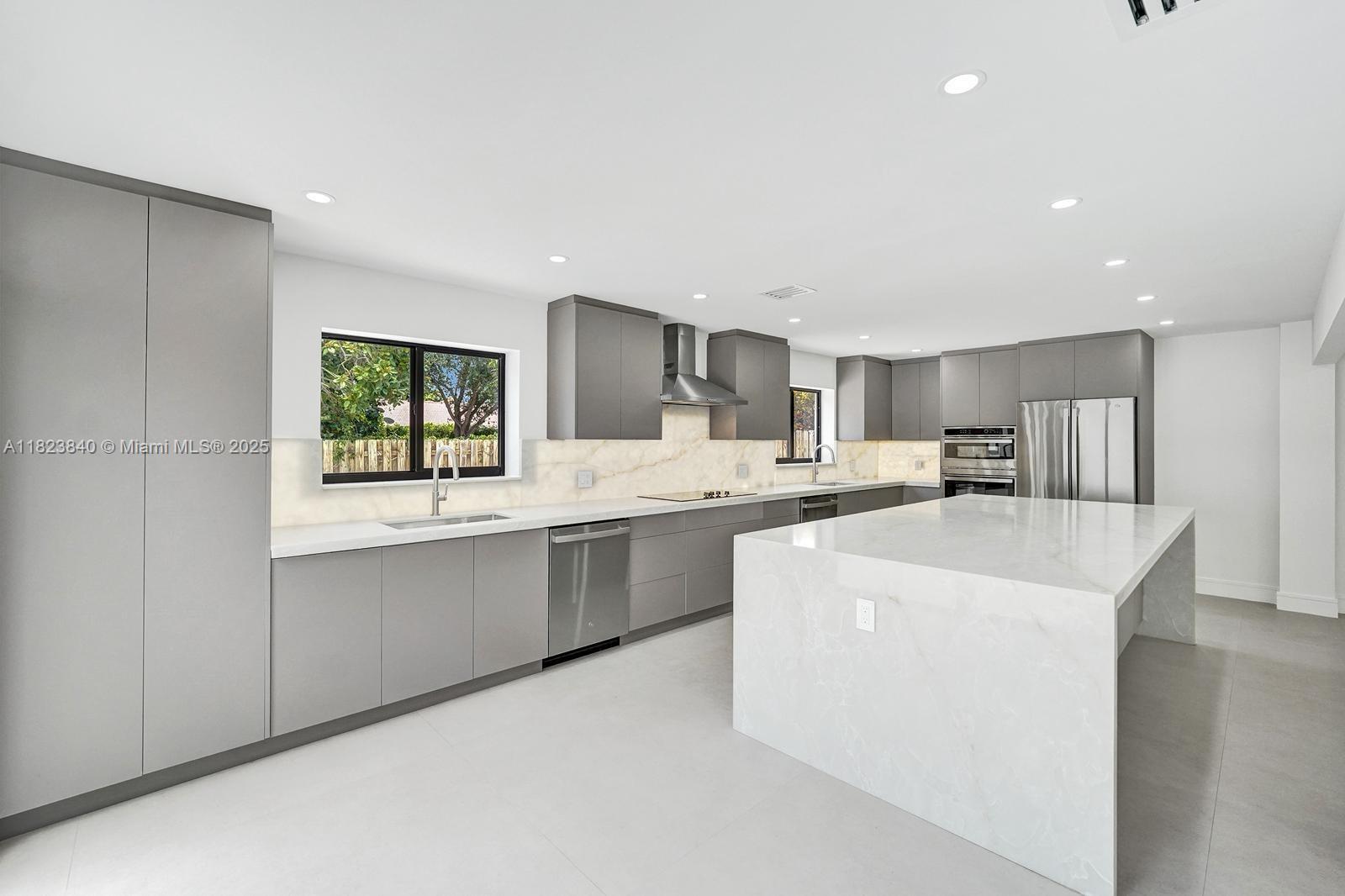 7340 Andorra Place Boca Raton, FL 33433 - Photo 10 of 99 a kitchen with stainless steel appliances a sink stove and cabinets