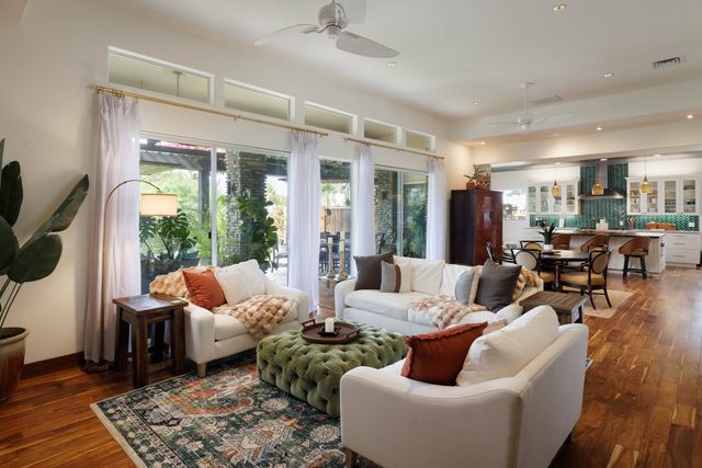 a living room with furniture fireplace and a large window