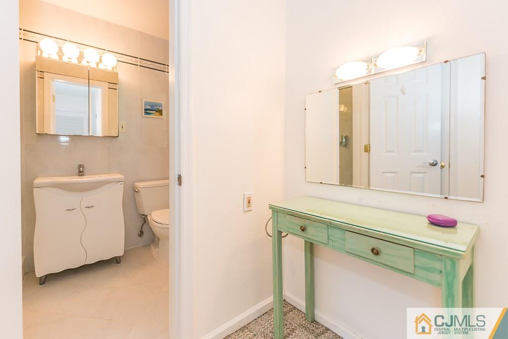 24 Taylor Road Princeton, NJ 08540 - Photo 15 of 25 a bathroom with a sink a vanity and a mirror