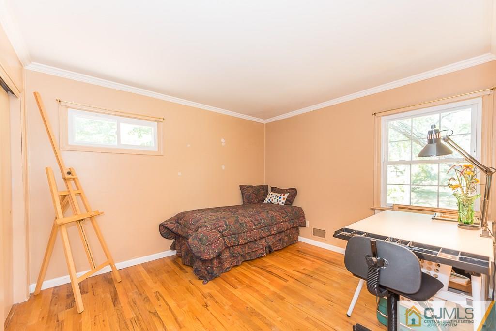 24 Taylor Road Princeton, NJ 08540 - Photo 17 of 25 a bedroom with a bed and wooden floor