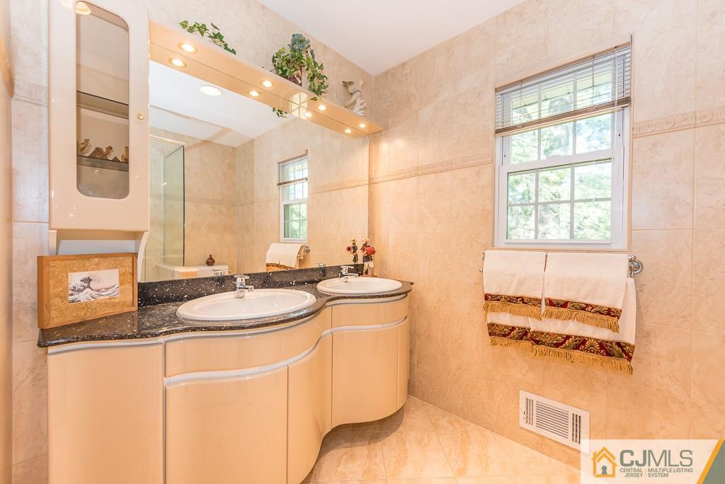 24 Taylor Road Princeton, NJ 08540 - Photo 18 of 25 a bathroom with a sink and a mirror