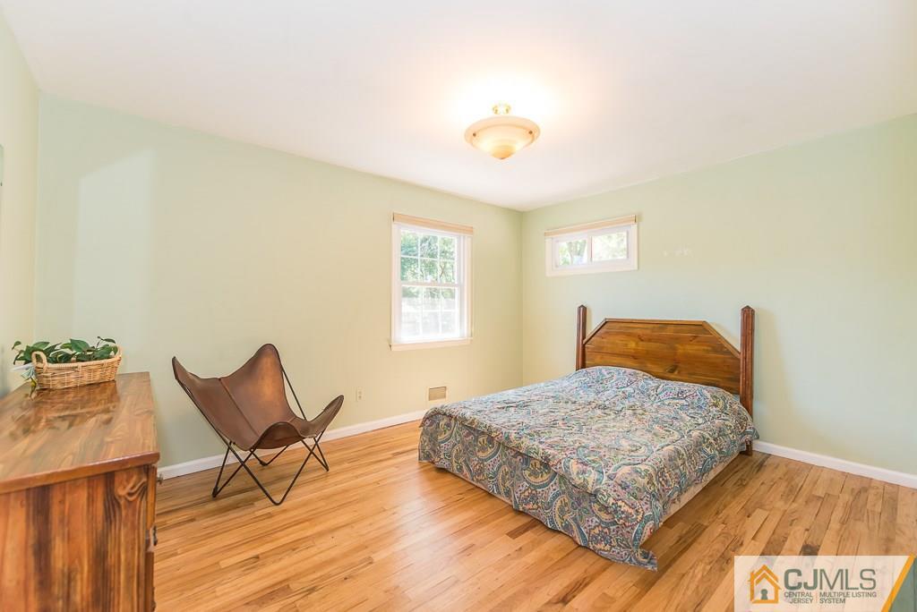 24 Taylor Road Princeton, NJ 08540 - Photo 19 of 25 a bedroom with a bed and wooden floor