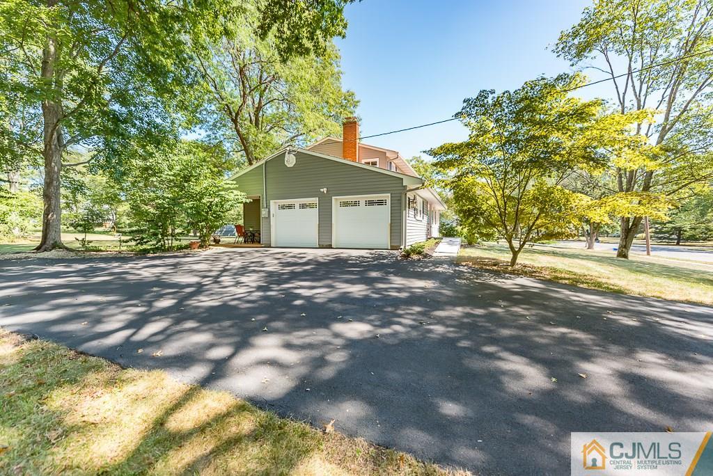 24 Taylor Road Princeton, NJ 08540 - Photo 23 of 25 a front view of a house with a yard and garage