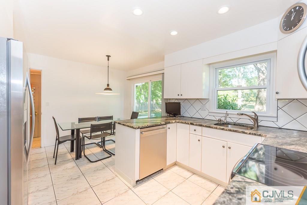 24 Taylor Road Princeton, NJ 08540 - Photo 5 of 25 a kitchen with a sink a counter top space and stainless steel appliances