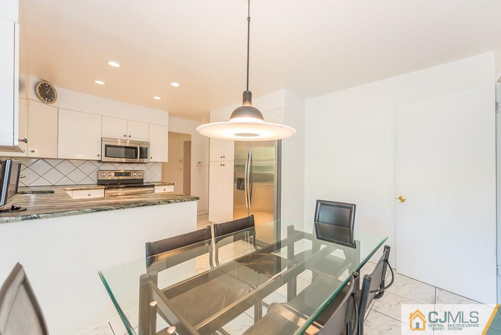 24 Taylor Road Princeton, NJ 08540 - Photo 8 of 25 a kitchen with stainless steel appliances granite countertop a sink stove and refrigerator