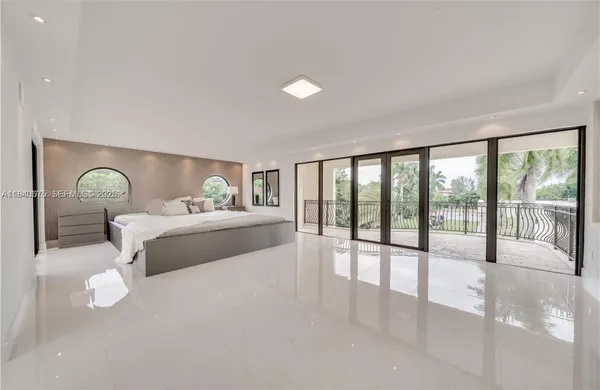 a bedroom with a large bed and a large window