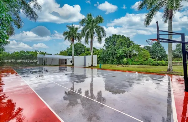 a view of a swimming pool with a lawn chairs under an umbrella