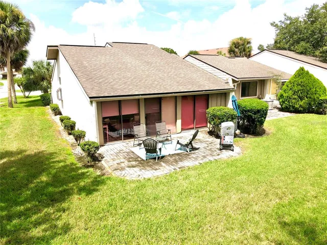 a view of a house with pool and sitting area