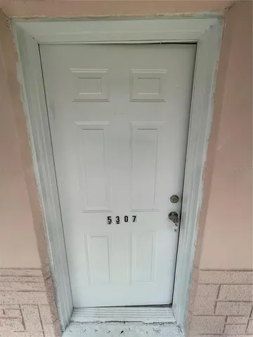 a kitchen with a refrigerator a stove top oven and white cabinets