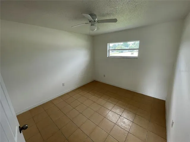 a view of a storage & utility room with refrigerator