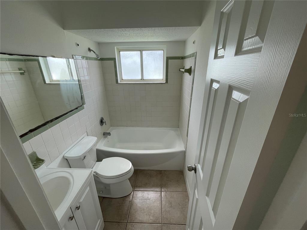 5305 Avery Road New Port Richey, FL 34652 - Photo 6 of 29 a white bath tub sitting next to a white toilet