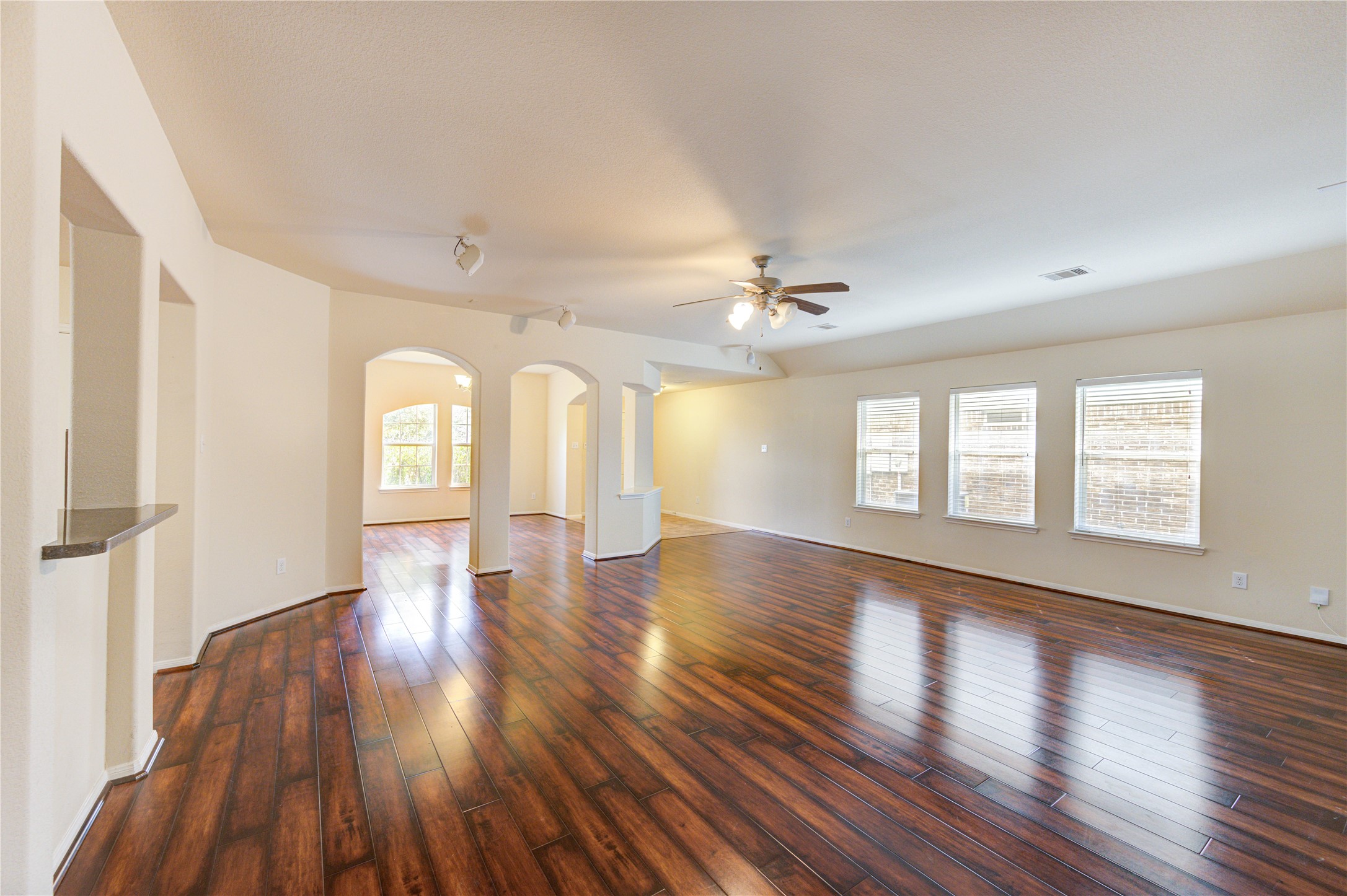 2922 Halcyon Time Trail Houston, TX 77045 - Photo 12 of 50 a view of an empty room with wooden floor and a window