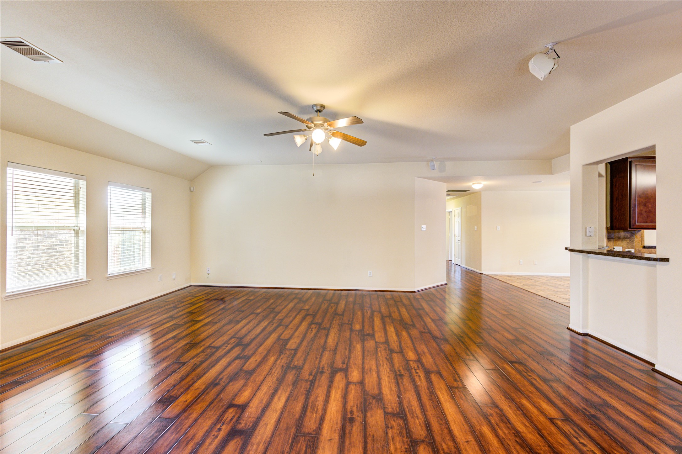 2922 Halcyon Time Trail Houston, TX 77045 - Photo 14 of 50 an empty room with wooden floor and windows