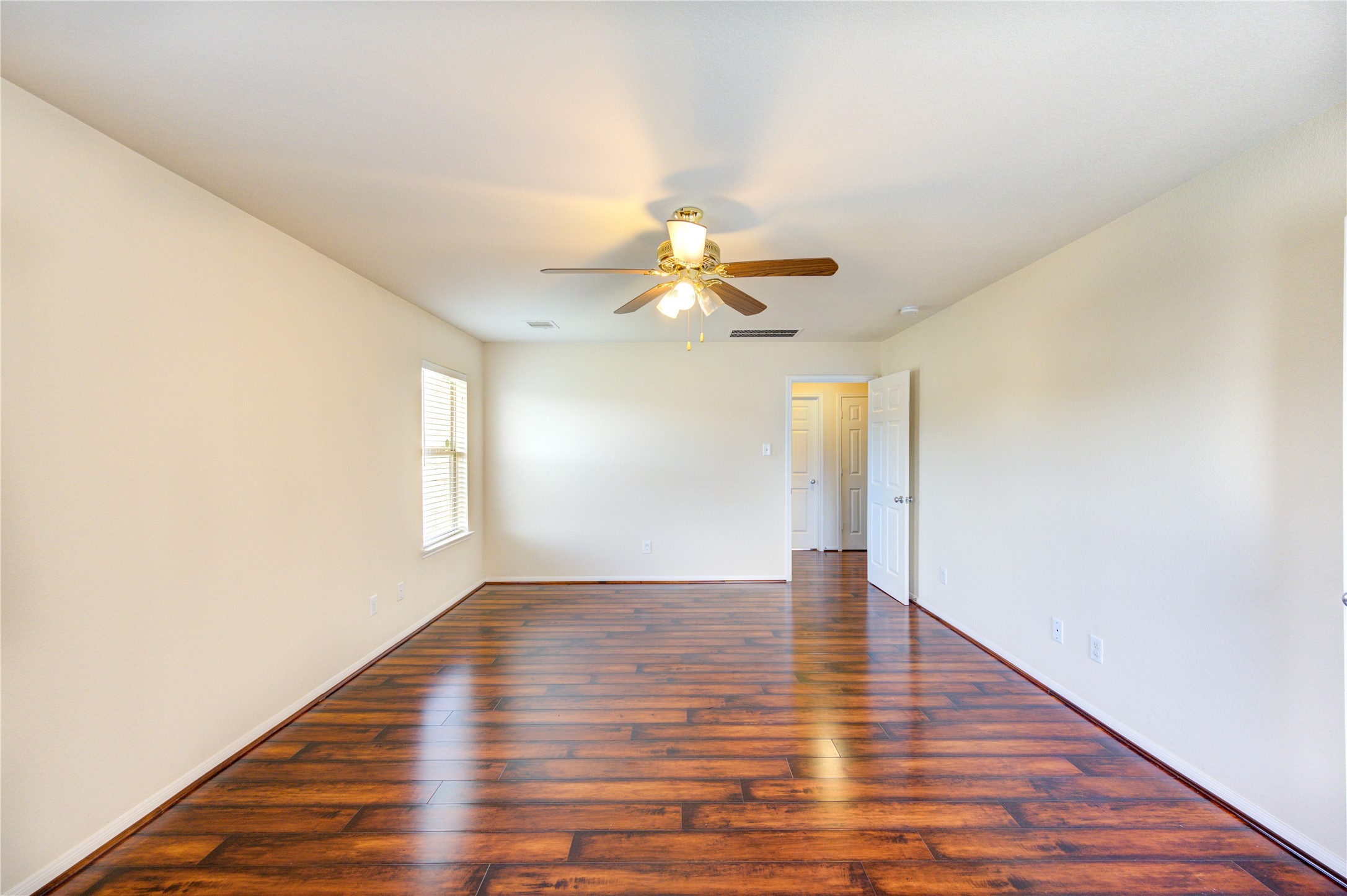 2922 Halcyon Time Trail Houston, TX 77045 - Photo 44 of 50 a view of an empty room with wooden floor and a window