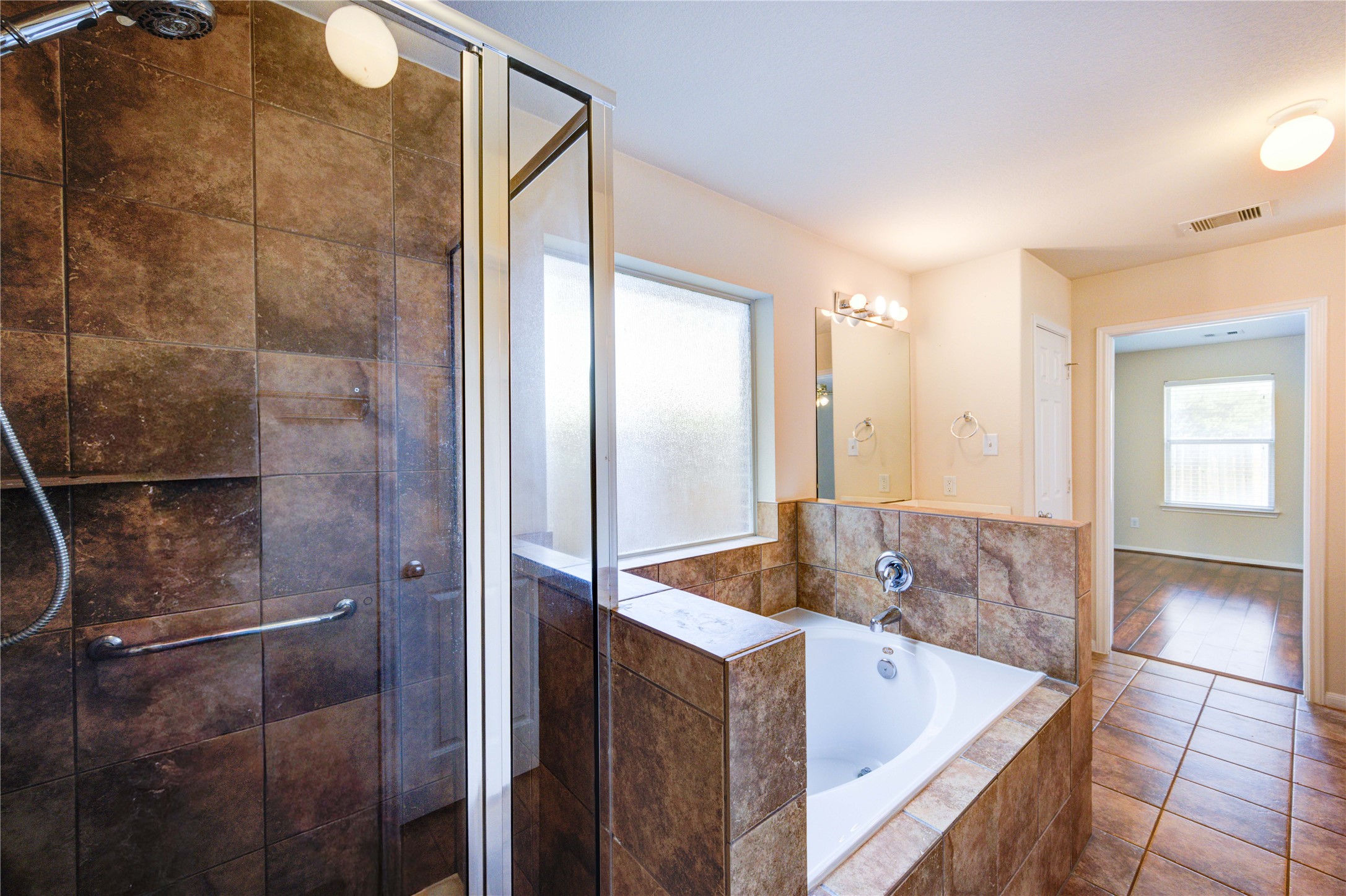 2922 Halcyon Time Trail Houston, TX 77045 - Photo 46 of 50 a bathroom with a tub and shower