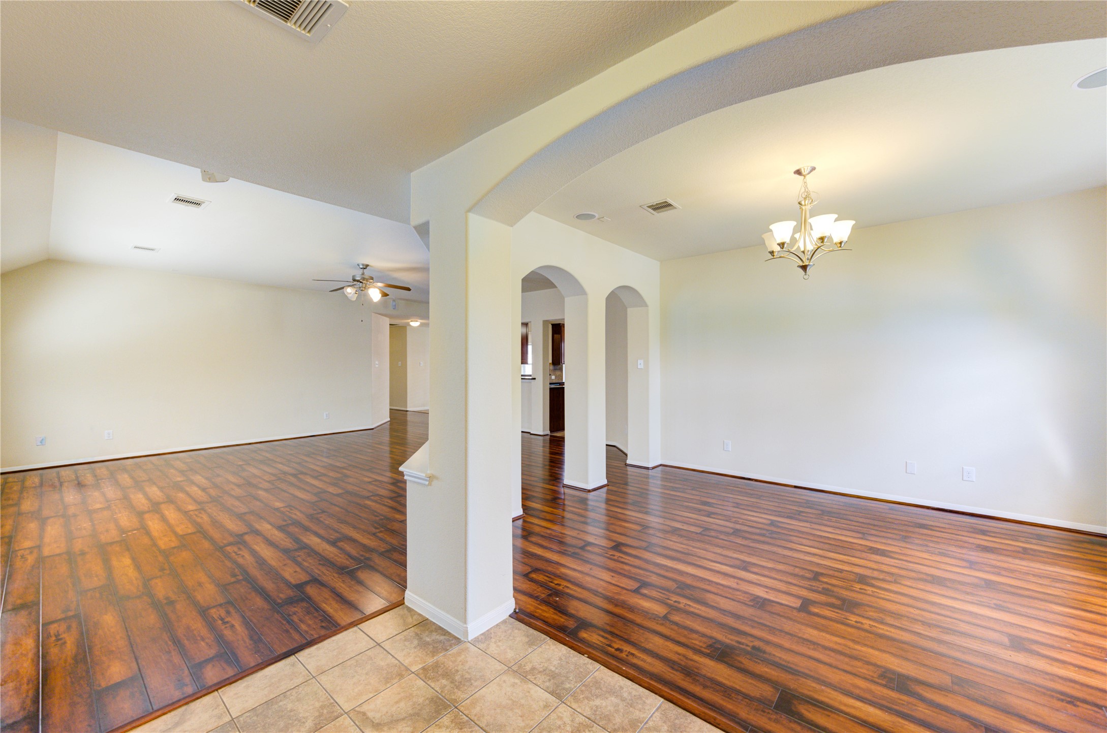 2922 Halcyon Time Trail Houston, TX 77045 - Photo 6 of 50 a view of a hallway with wooden floor and a chandelier