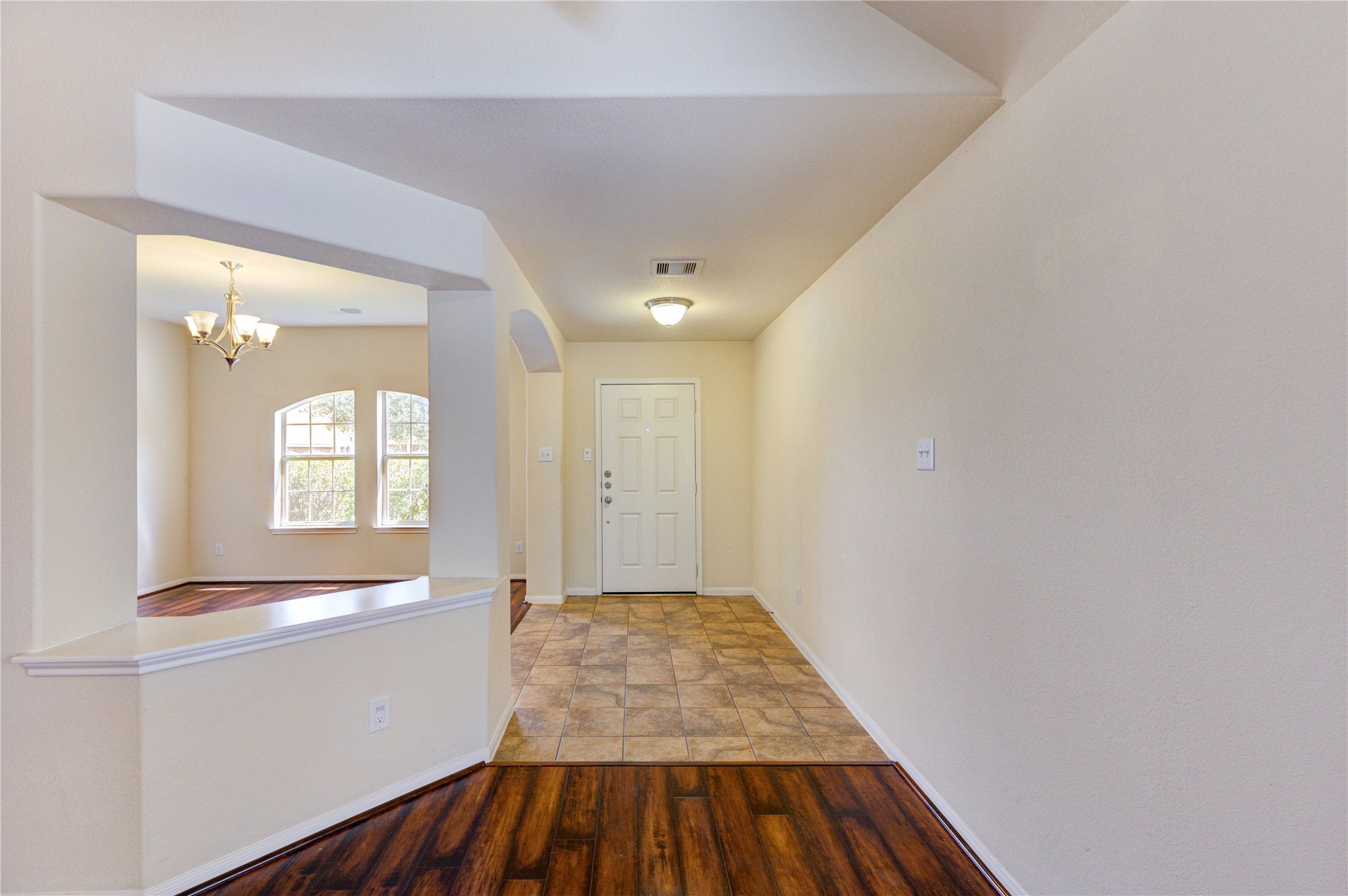 2922 Halcyon Time Trail Houston, TX 77045 - Photo 7 of 50 a view of a hallway with wooden floor and a bathroom