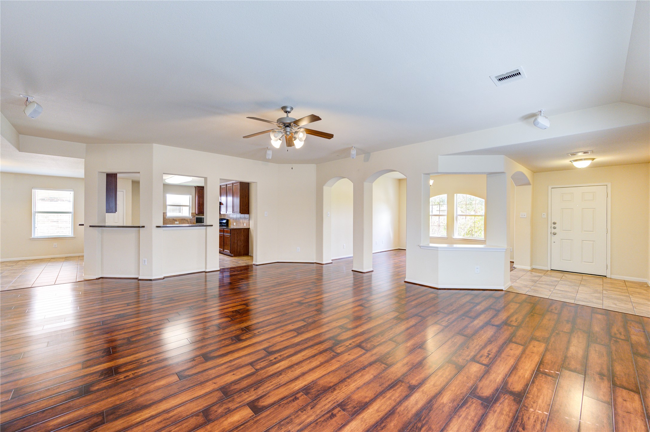 2922 Halcyon Time Trail Houston, TX 77045 - Photo 9 of 50 an empty room with wooden floor and windows