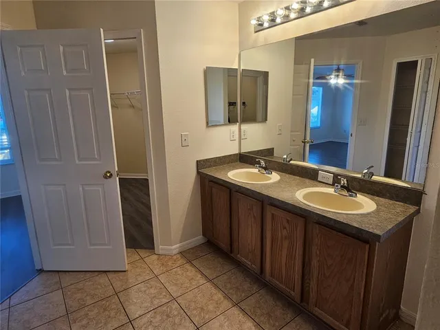 a bathroom with a double vanity sink and mirror