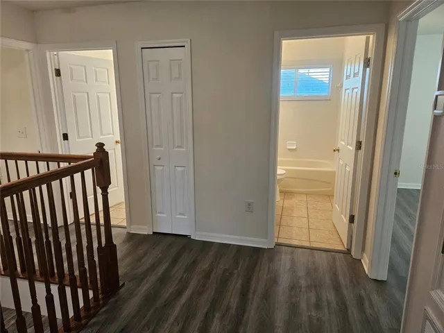 a view of a room with wooden floor and door