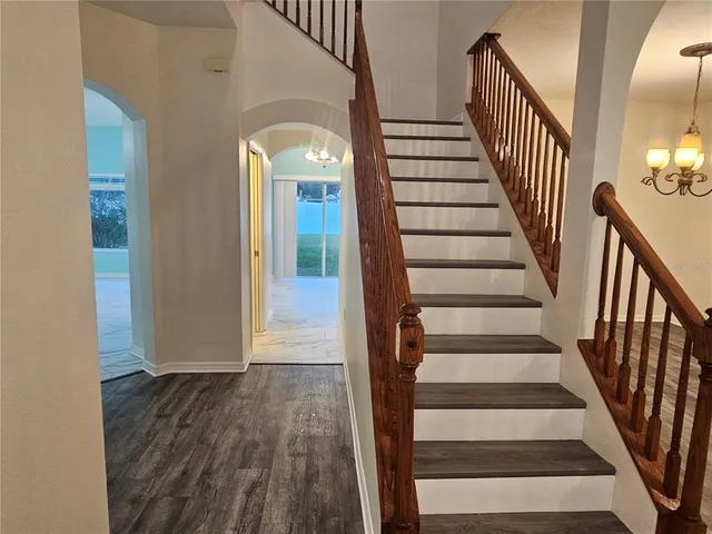 a view of staircase with wooden floor and a window