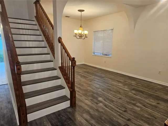 a view of entryway wooden floor and chandelier