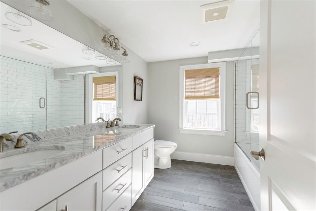 64 County Road, Unit 1 Ipswich, MA 01938 - Photo 23 of 33 a spacious bathroom with a double vanity sink a toilet and a tub