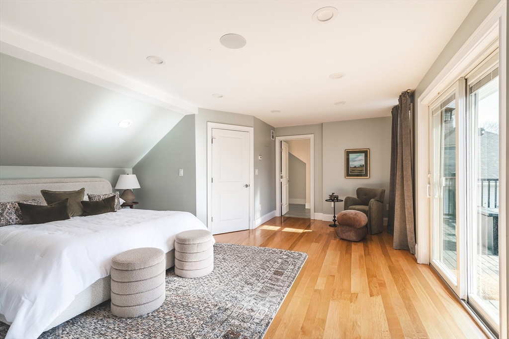 64 County Road, Unit 1 Ipswich, MA 01938 - Photo 24 of 33 a spacious bedroom with a bed and wooden floor