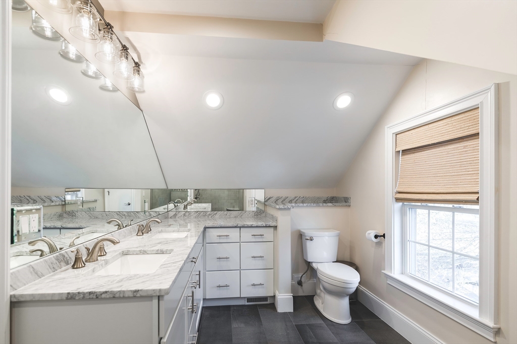 64 County Road, Unit 1 Ipswich, MA 01938 - Photo 28 of 33 a bathroom with a granite countertop sink mirror vanity and toilet