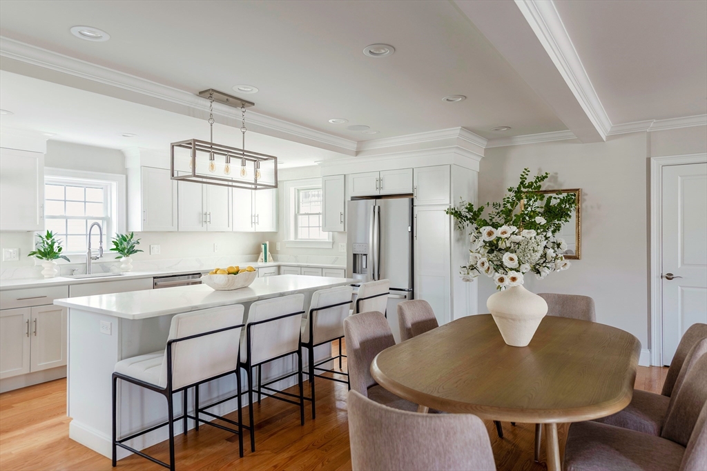 64 County Road, Unit 1 Ipswich, MA 01938 - Photo 4 of 33 a kitchen with stainless steel appliances granite countertop a dining table chairs and chandelier