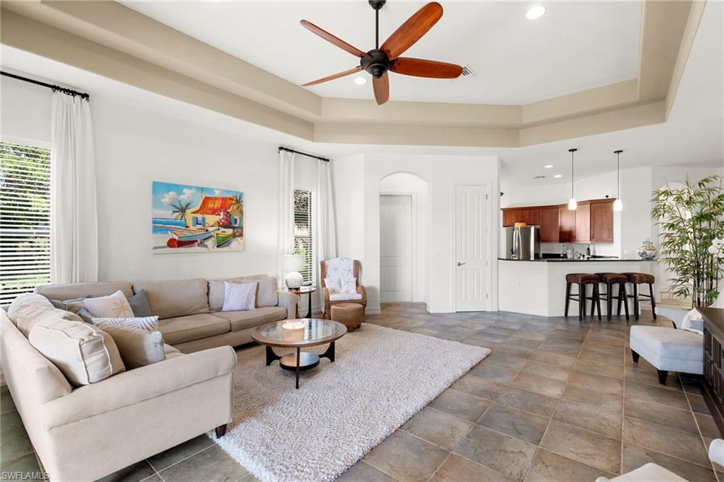 7563 Moorgate Point Way Naples, FL 34113 - Photo 12 of 40 a living room with furniture and a flat screen tv