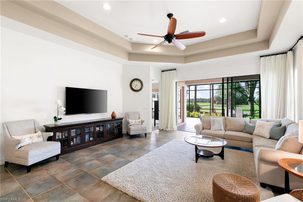 7563 Moorgate Point Way Naples, FL 34113 - Photo 13 of 40 a living room with furniture and a flat screen tv