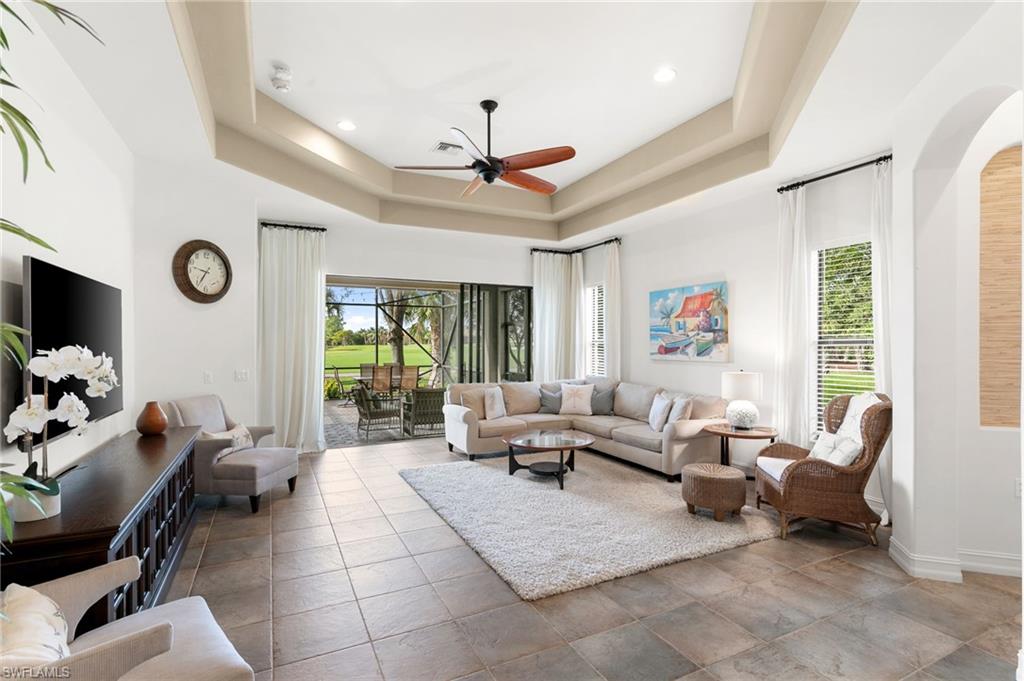 7563 Moorgate Point Way Naples, FL 34113 - Photo 15 of 40 a living room with furniture and a large window