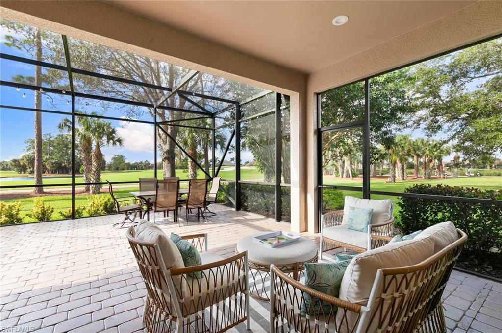 7563 Moorgate Point Way Naples, FL 34113 - Photo 2 of 40 a view of an outdoor dining space with a patio
