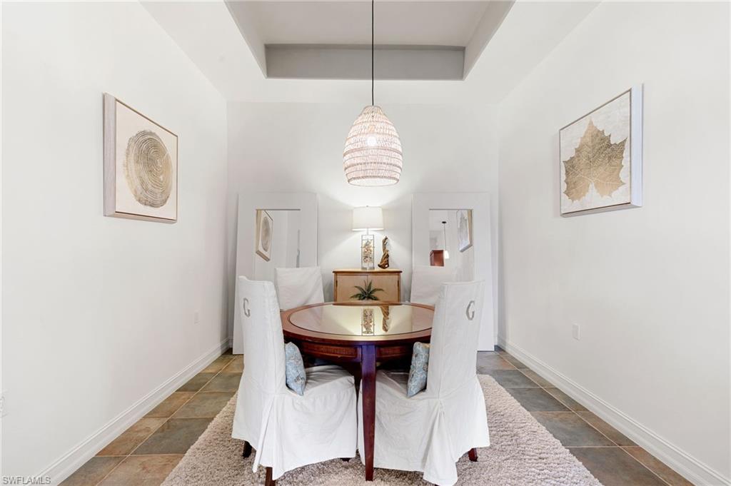 7563 Moorgate Point Way Naples, FL 34113 - Photo 21 of 40 a dining room with table and chairs