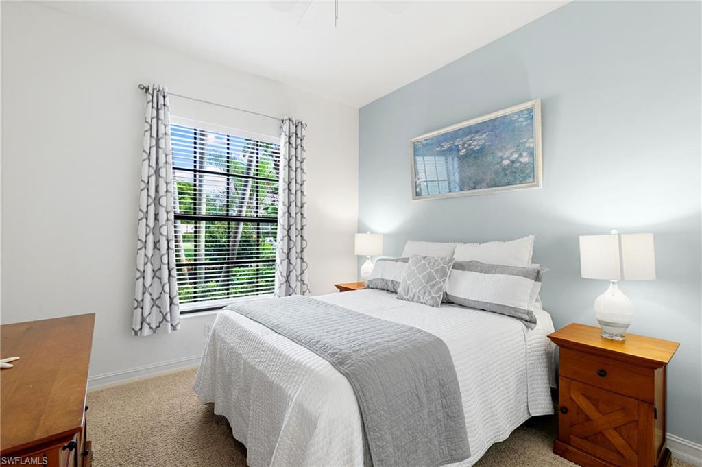 7563 Moorgate Point Way Naples, FL 34113 - Photo 25 of 40 a bedroom with bed and window