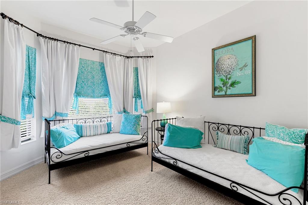 7563 Moorgate Point Way Naples, FL 34113 - Photo 27 of 40 a bedroom with a bed and a chandelier